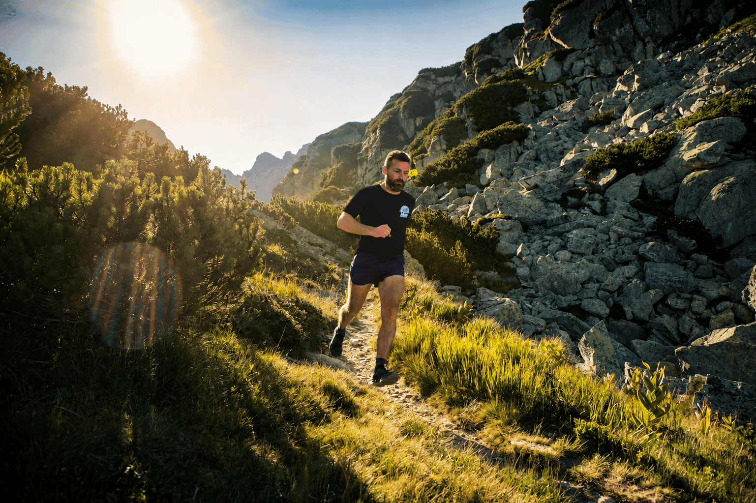 Trail runner on a Sierra Nevada mountain trail at sunrise
